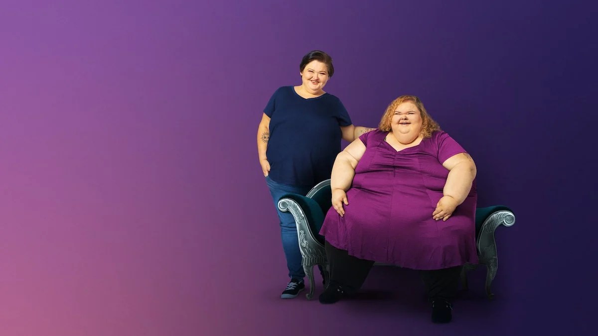 Amy Slaton Halterman and Tammy Willingham posing together in front of a purple background for '1,000-lb Sisters' Season 4 promo for TLC.