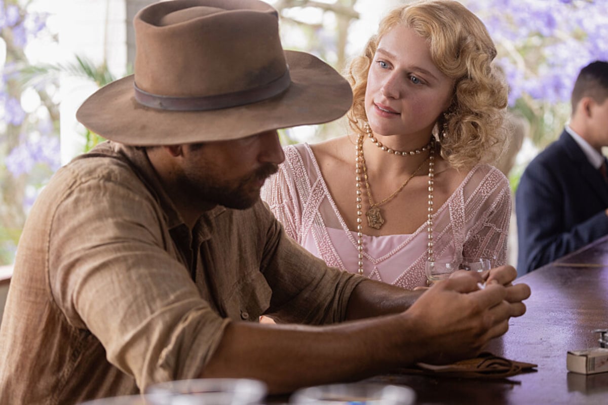 In 1923 Spencer Dutton talks to Alexandra while sitting at a bar in Africa.