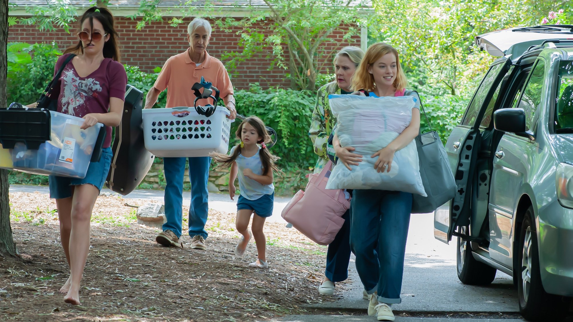 'A Little Prayer' Anna Camp as Patti, David Strathairn as Bill, Billie Roy as Hadley, Celia Weston as Venida, and Jane Levy as Tammy holding boxes, baskets, and pillows from a car and walking on the dirt path