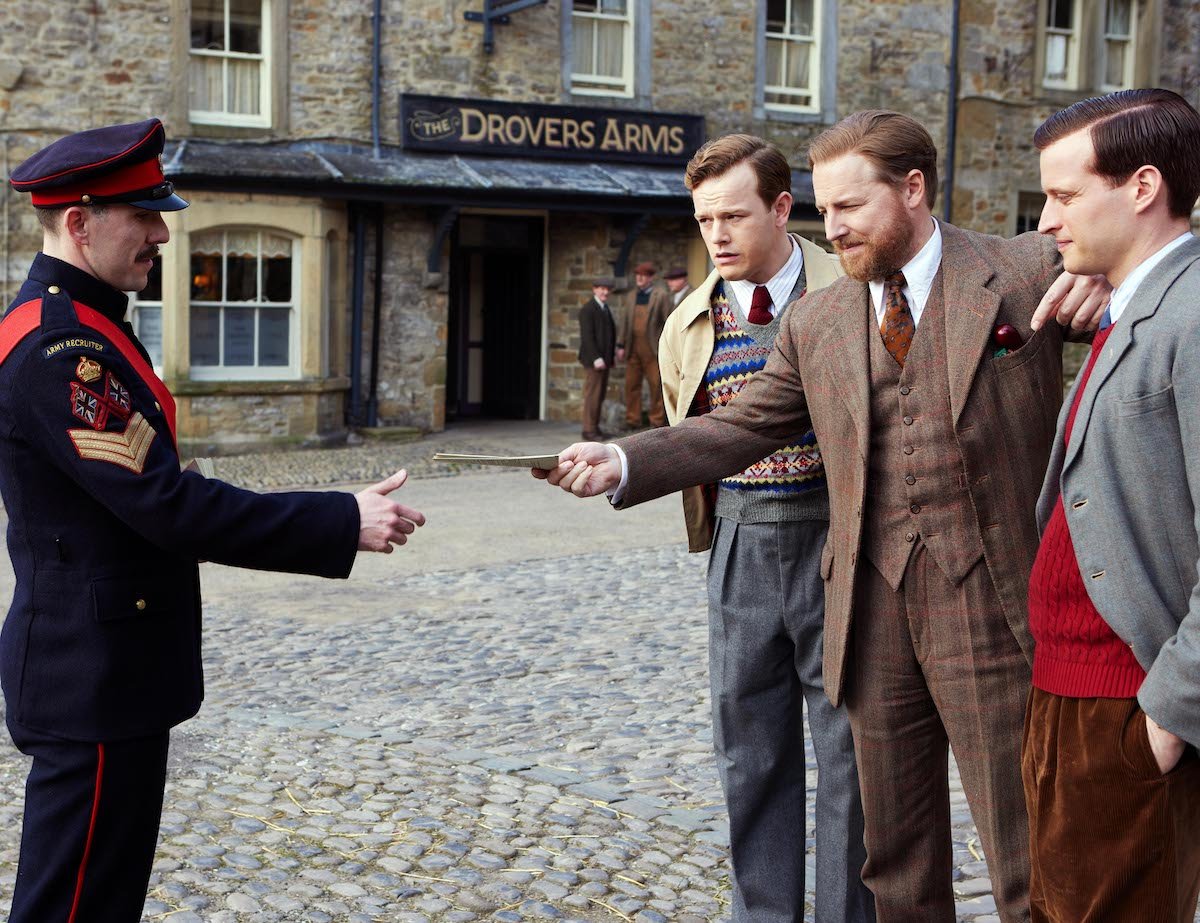 Three men talking to a soldier in 'All Creatures Great and Small,' which is filmed in Grassington in the UK