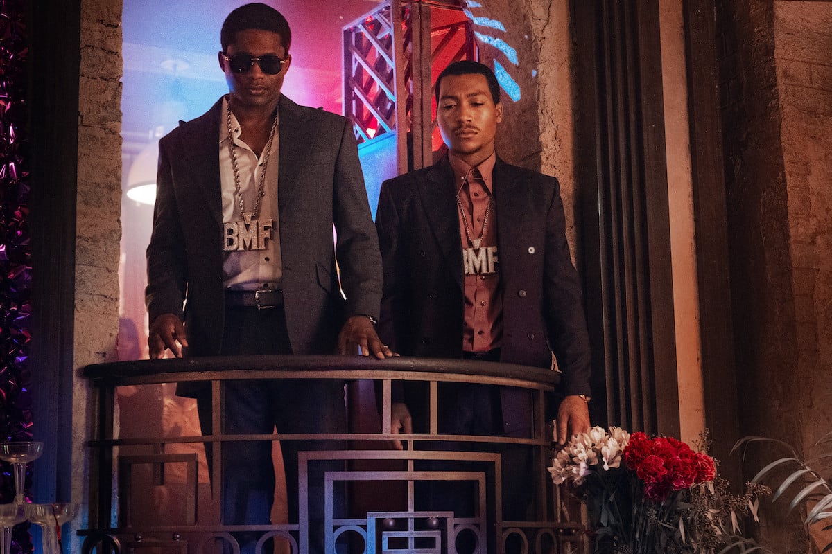 Demetrius “Lil Meech” Flenory Jr. as Meech and Da'Vinchi as Terry wearing chains and standing on a balcony in 'BMF'