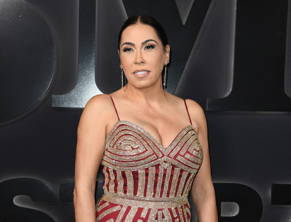 Tammy Cowins attends the red carpet premiere of Starz "BMF" Season 2 wearing a glittering gold and red gown