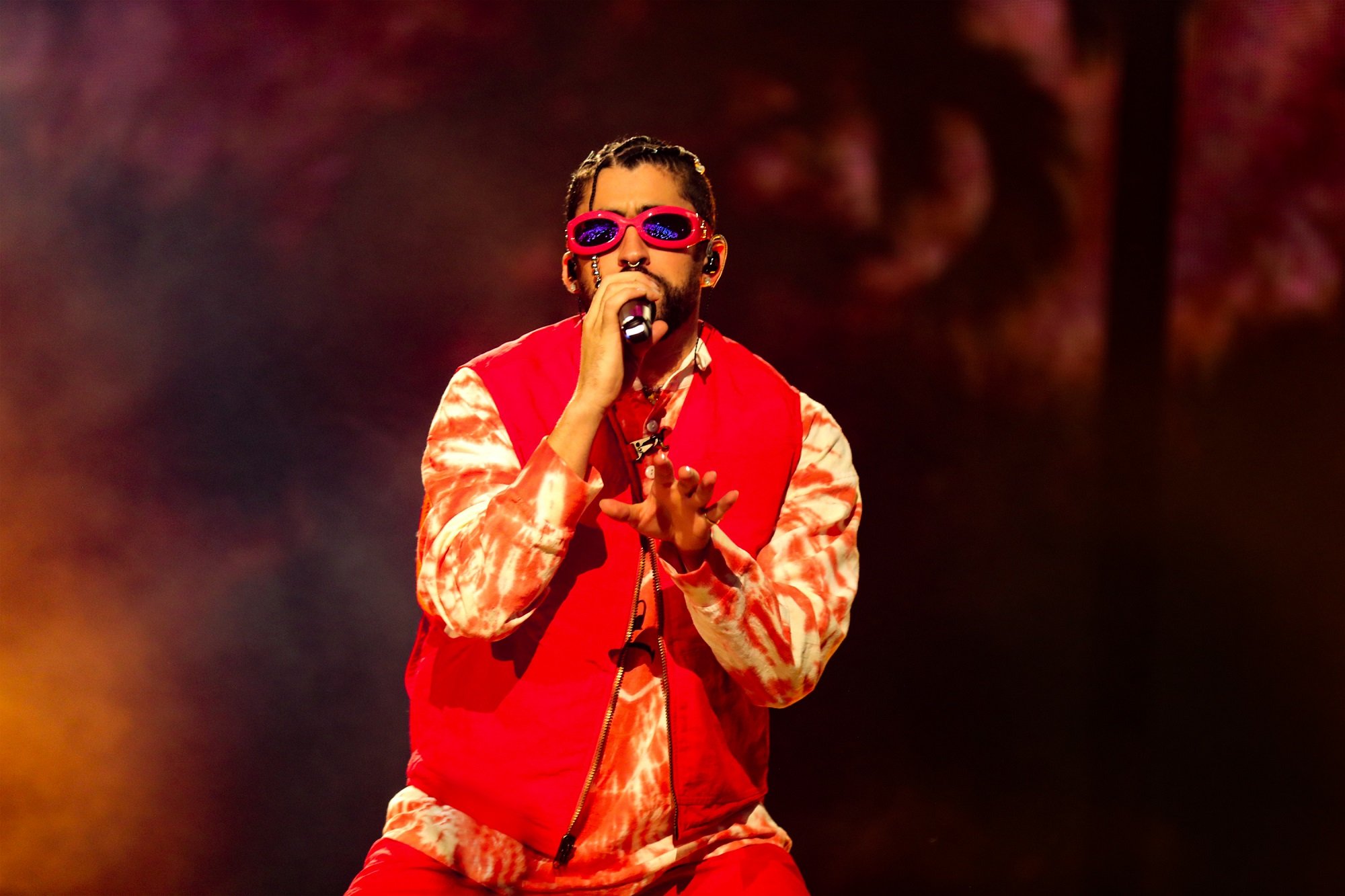 Bad Bunny performs wearing a red outfit and red sunglasses