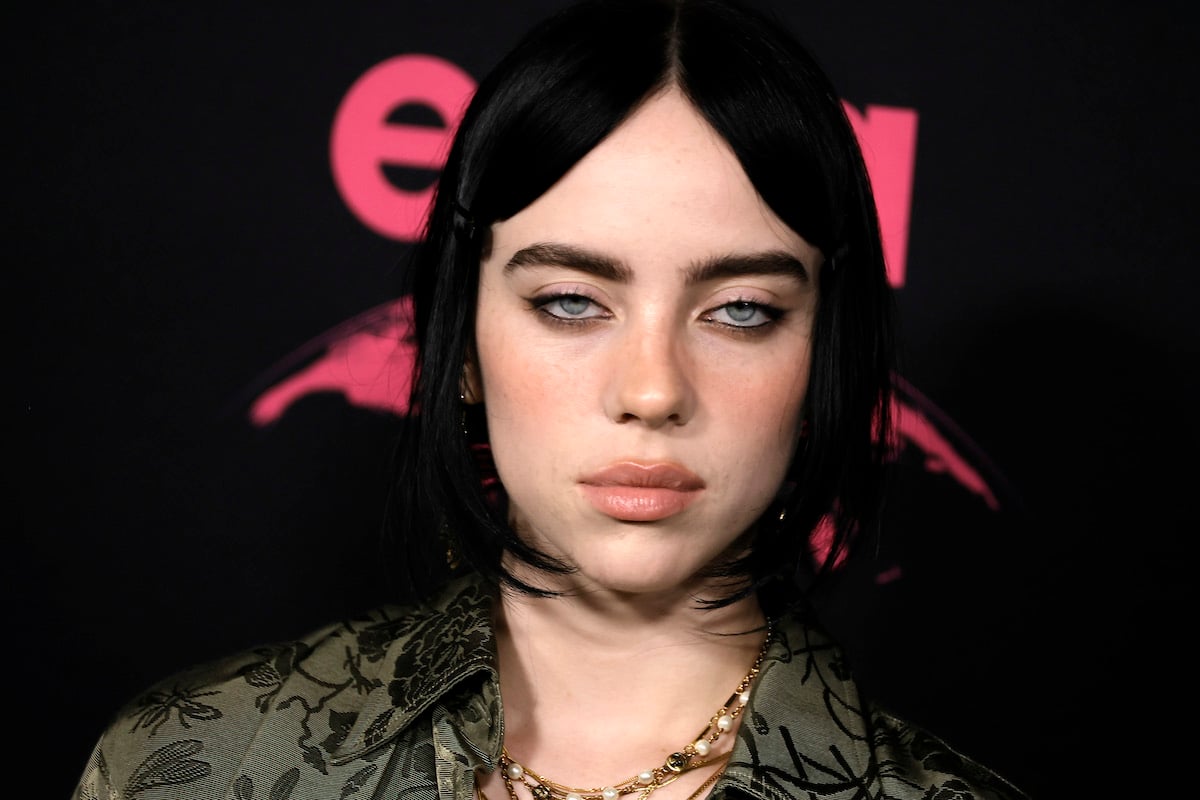 Billie Eilish poses unsmiling at an event.