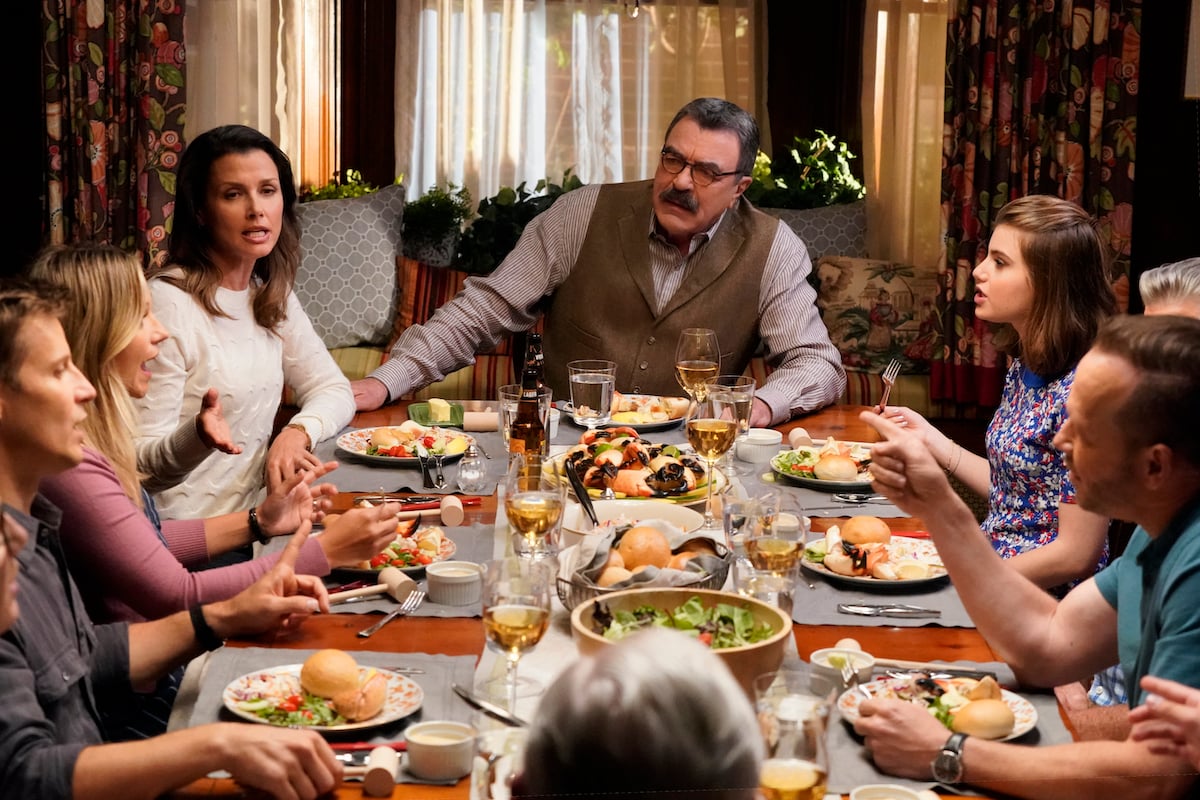 Blue Bloods patriarch Frank Reagan is portrayed by Tom Selleck at a family dinner