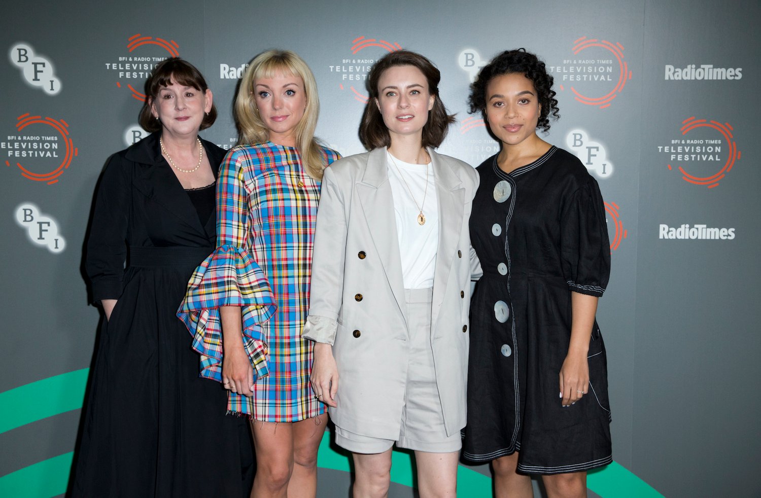 Heidi Thomas, Helen George, Jennifer Kirby, and Leonie Elliott from the 'Call the Midwife' Season 12 cast standing together at an event