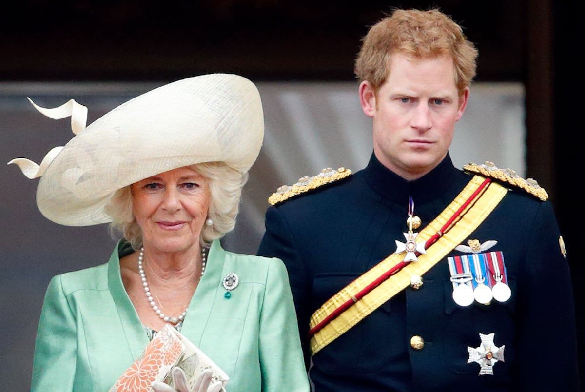 Camilla Parker Bowles and Prince Harry, who recalled meeting his stepmother in 'Spare', stand on the Buckingham Palace balcony