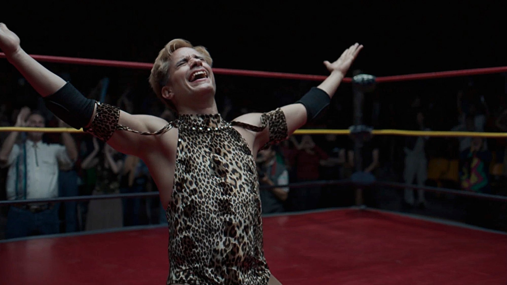 'Cassandro' Gael García Bernal as Saúl Armendáriz in an animal print costume, throwing his arms up in the air