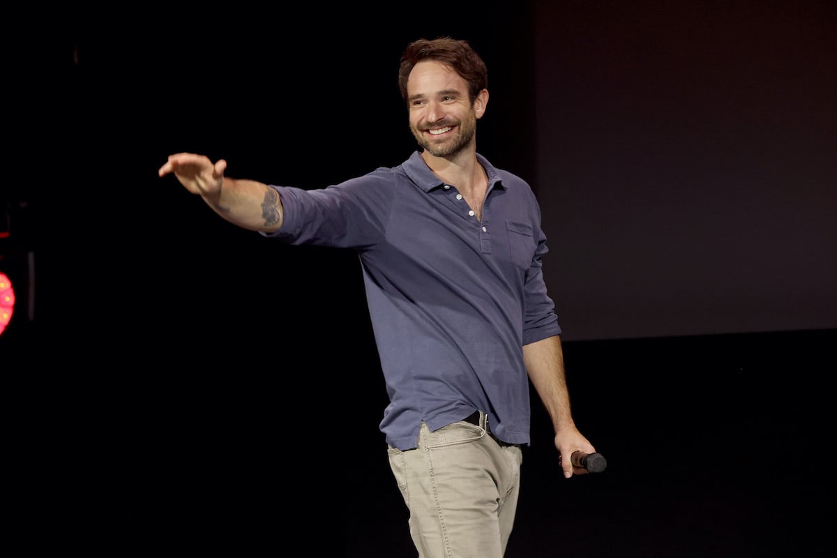 Charlie Cox smiling, waving at a crowd