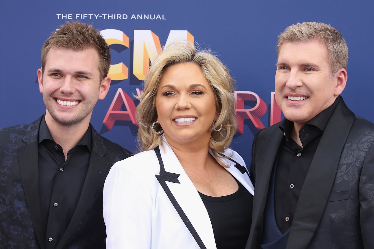 "Chrisley Knows Best" stars Chase Chrisley, Julie Chrisley, and Todd Chrisley smile together at an event.