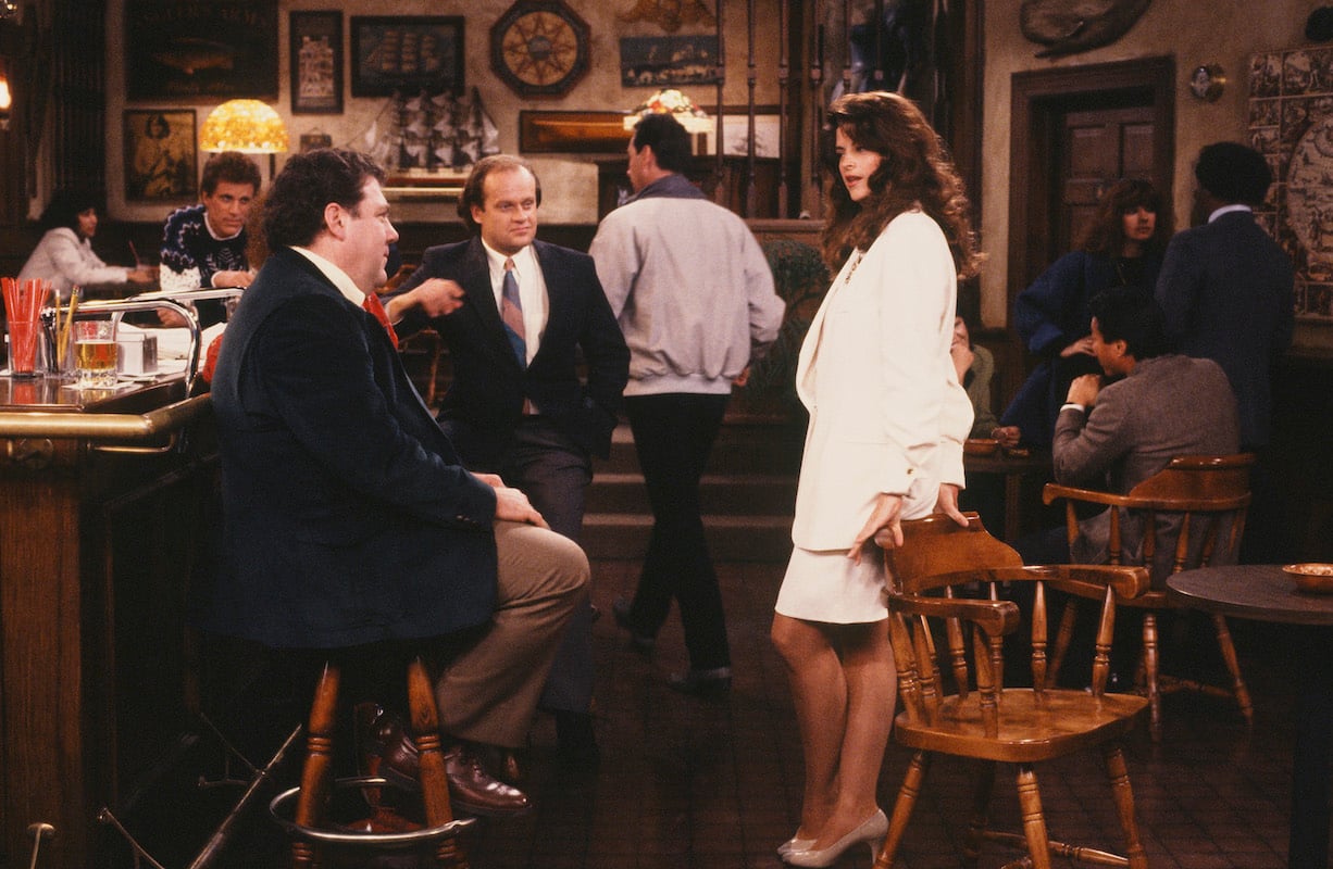 'Cheers': Kirstie Alley leans on a chair talking to George Wendt and Kelsey Grammer