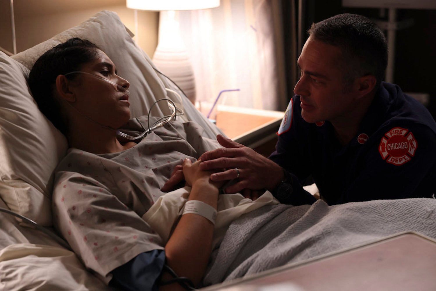 Stella Kidd in a hospital bed with Kelly Severide by her side in 'Chicago Fire' Season 11 Episode 10