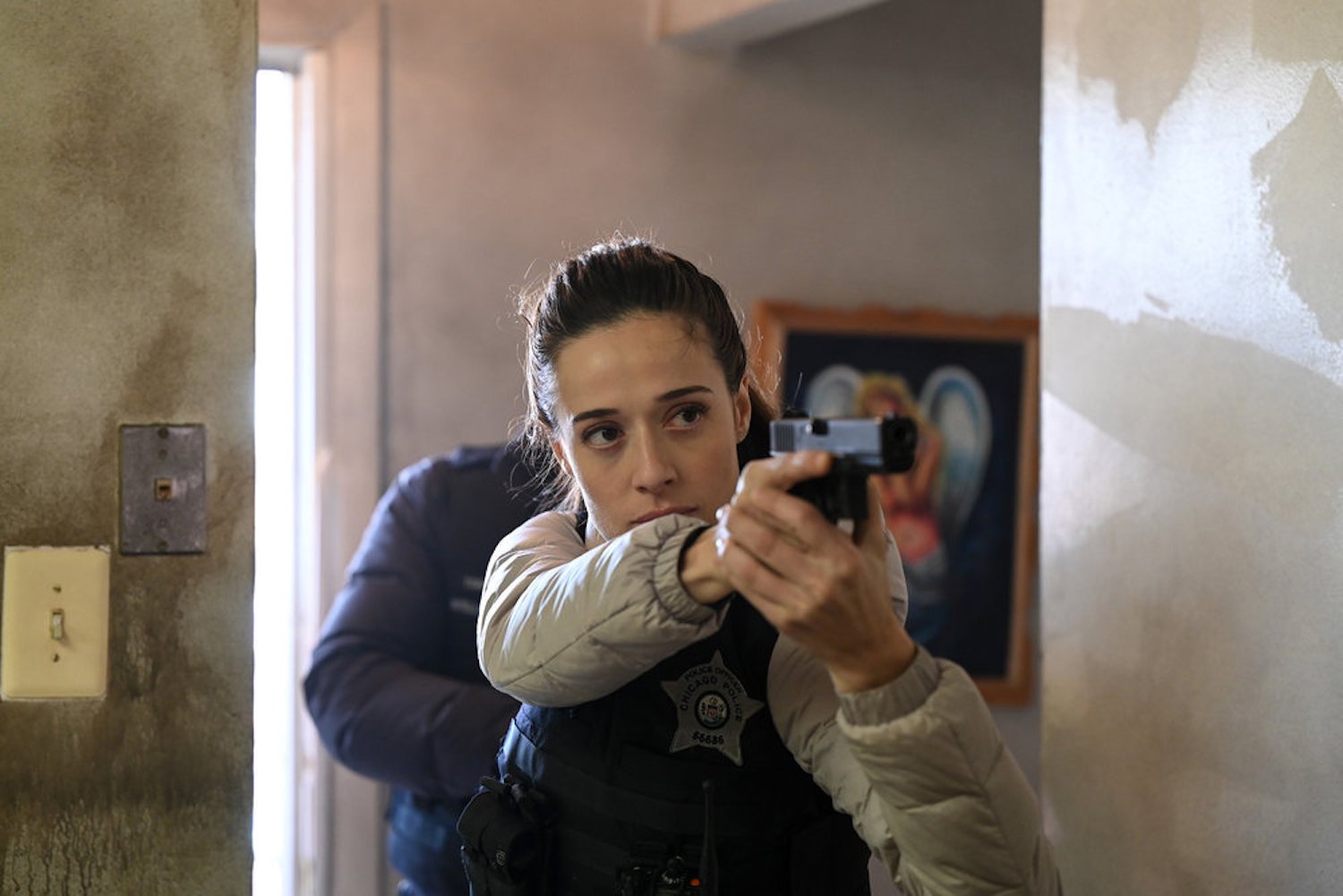 Kim Burgess entering a room holding up a gun in 'Chicago P.D.' Season 10 Episode 10
