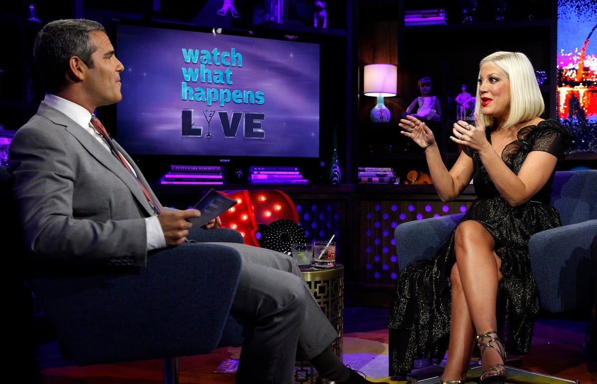 Tori Spelling sits across from Andy Cohen during an appearance on 'Watch What Happens Live with Andy Cohen. Cohen doesn't see Tori Spelling as a member of 'The Real Housewives of Beverly Hills'