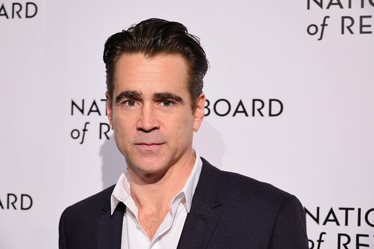 Colin Farrell poses for photos in front of a white backdrop.