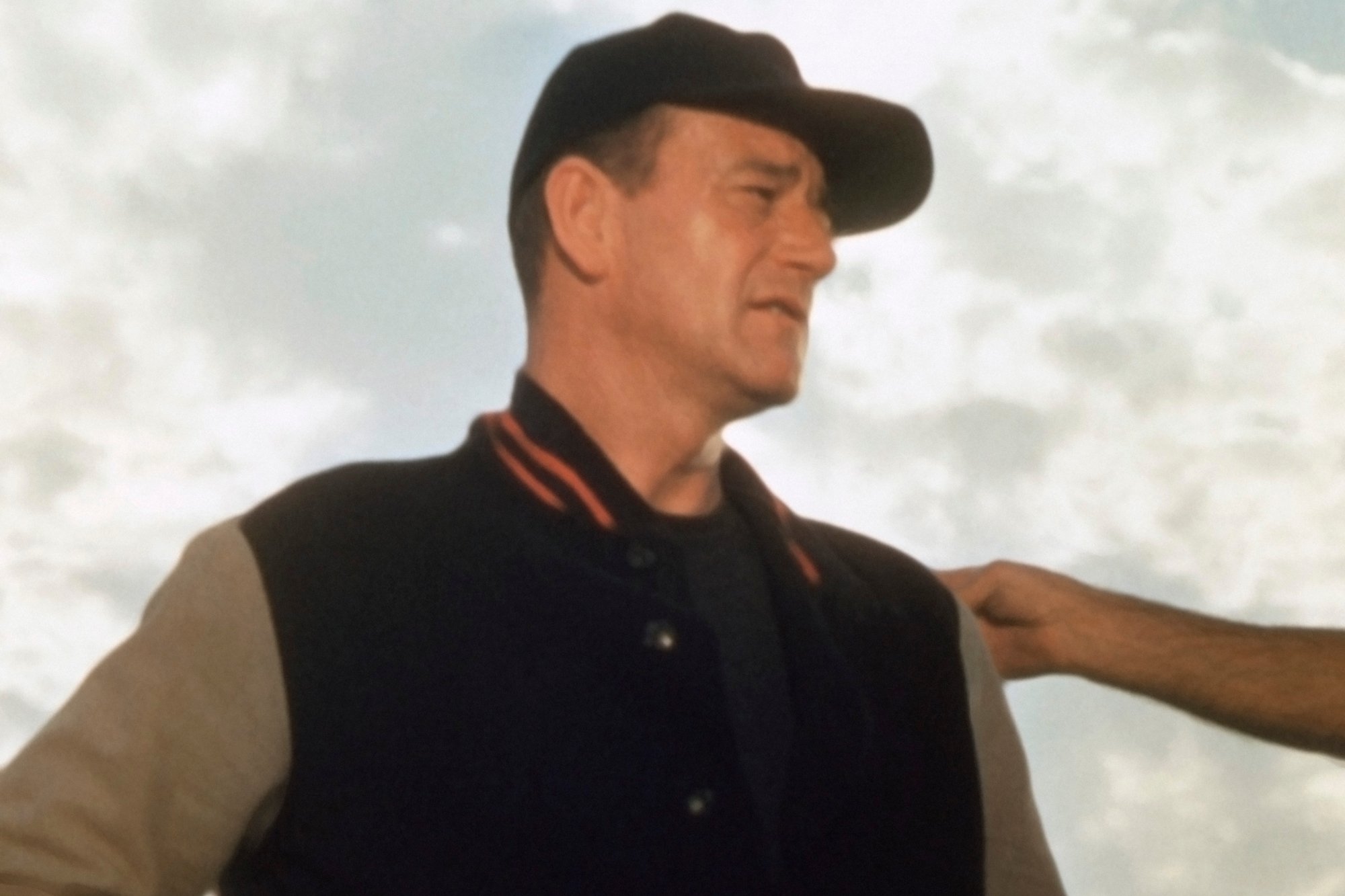 College football player John Wayne wearing a football coach uniform looking off-camera