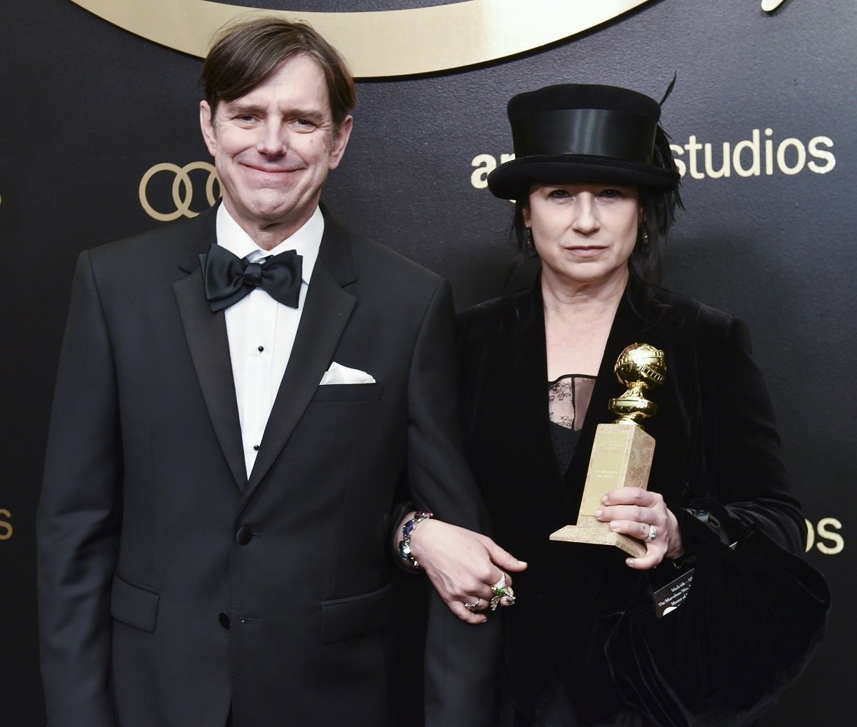 Dan Palladino and Amy Sherman-Palladino pose for a photo at the Amazon Studios Golden Globes Celebration