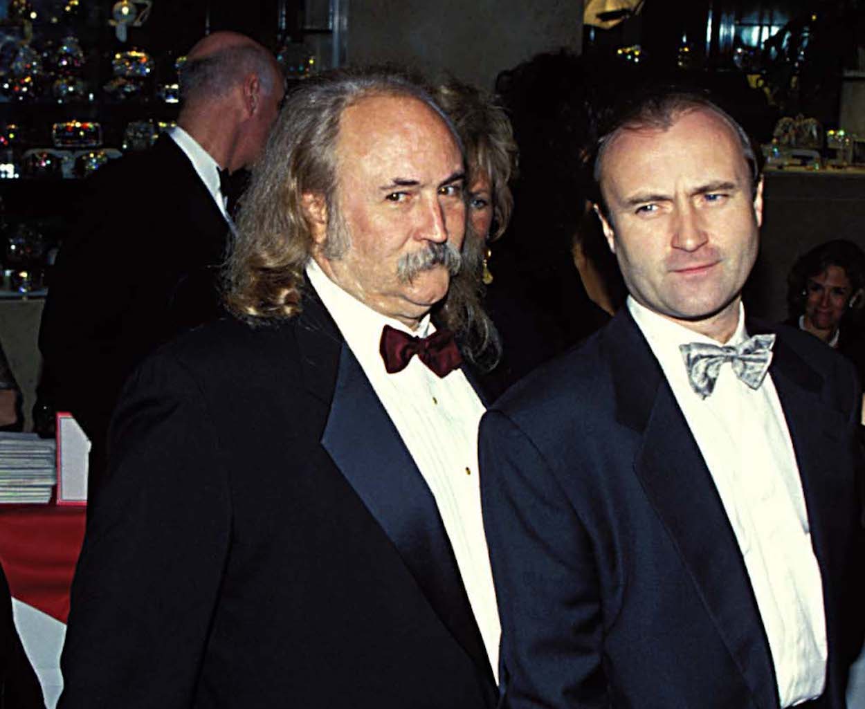 David Crosby (left) and Phil Collins attend the AFI Tribute to Steven Spielberg in December 1995.