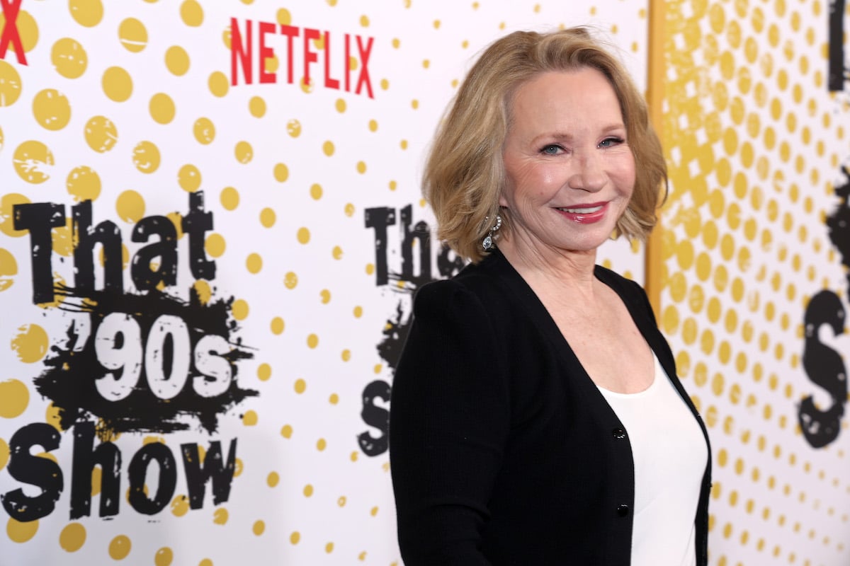 Debra Jo Rupp poses for photos in front of a"That '90s Show" backdrop