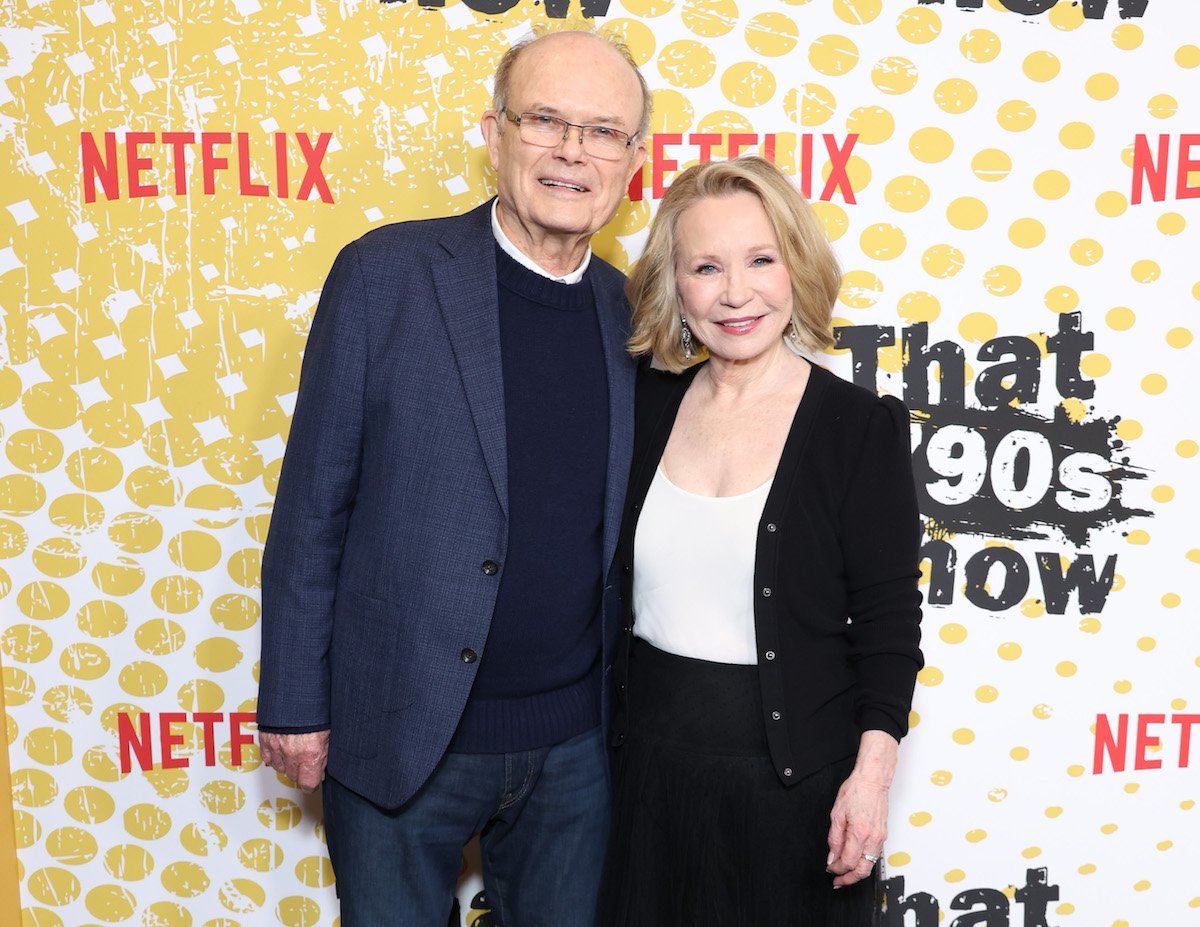 Kurtwood Smith and Debra Jo Rupp pose for photos in front of a "That 90s Show" backdrop.