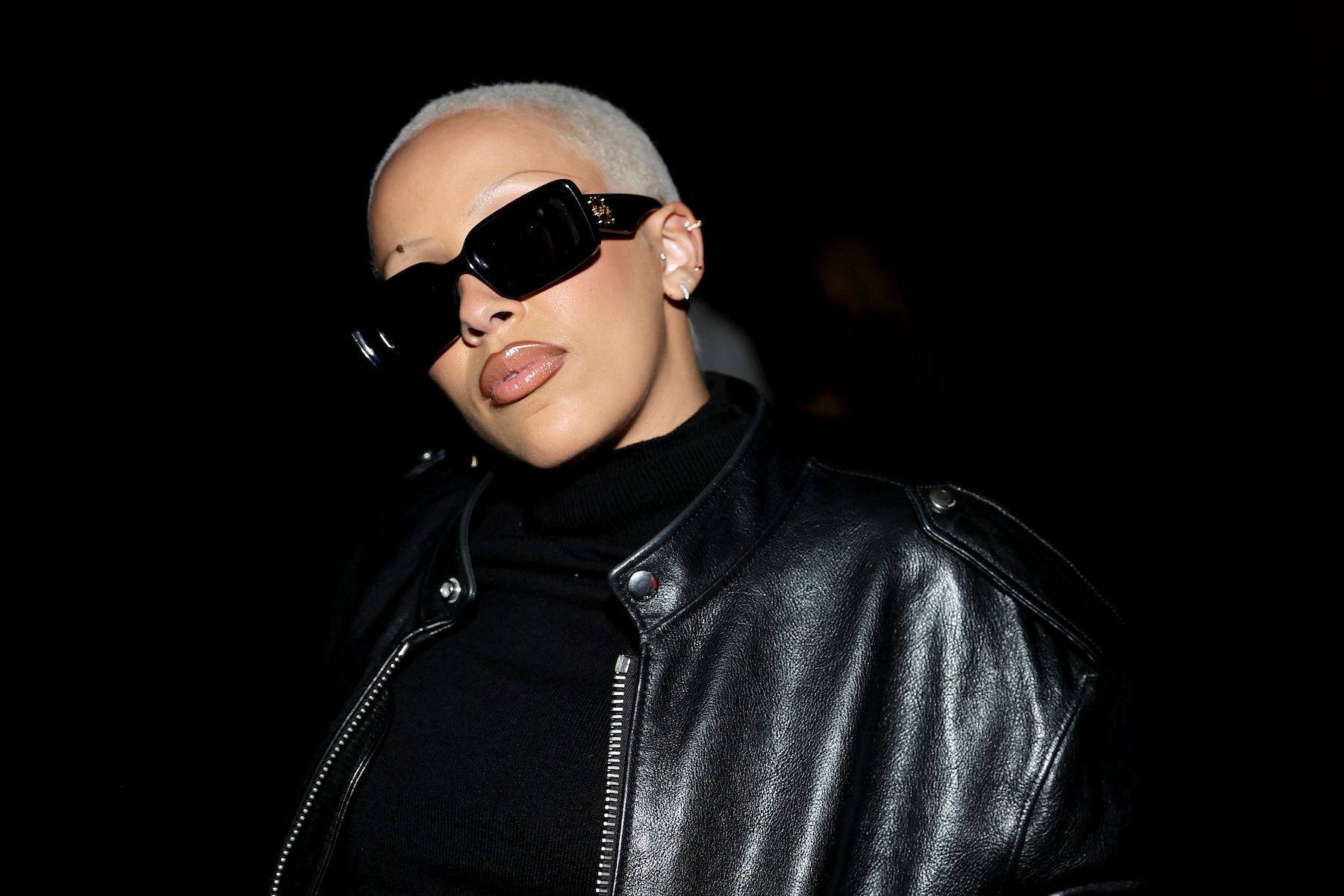 Doja Cat, who came under controversy for being in 'incel' chat rooms online, posing for a photo wearing sunglasses and a black leather jacket