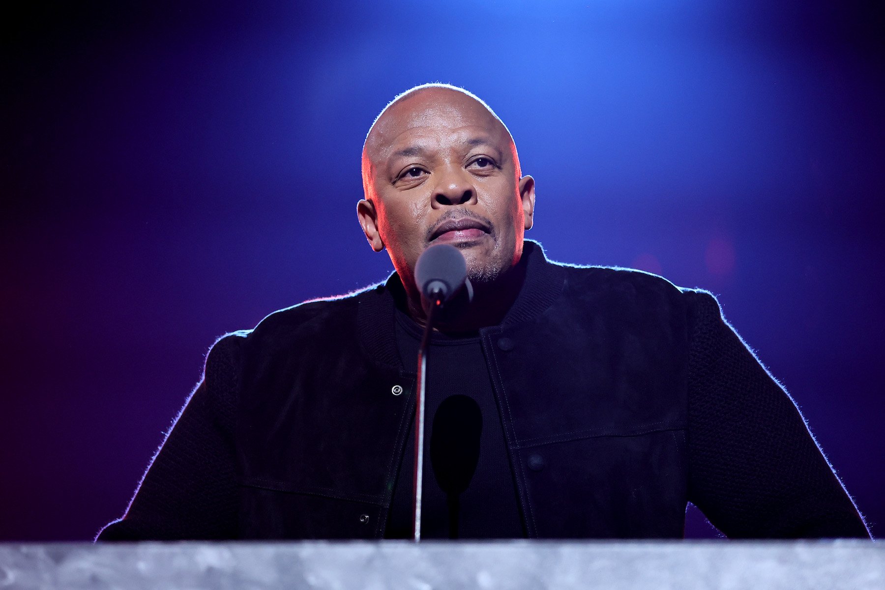 Dr. Dre, who recently issued Rep. Marjorie Taylor Greene a cease and desist for using his music, standing at a podium wearing black