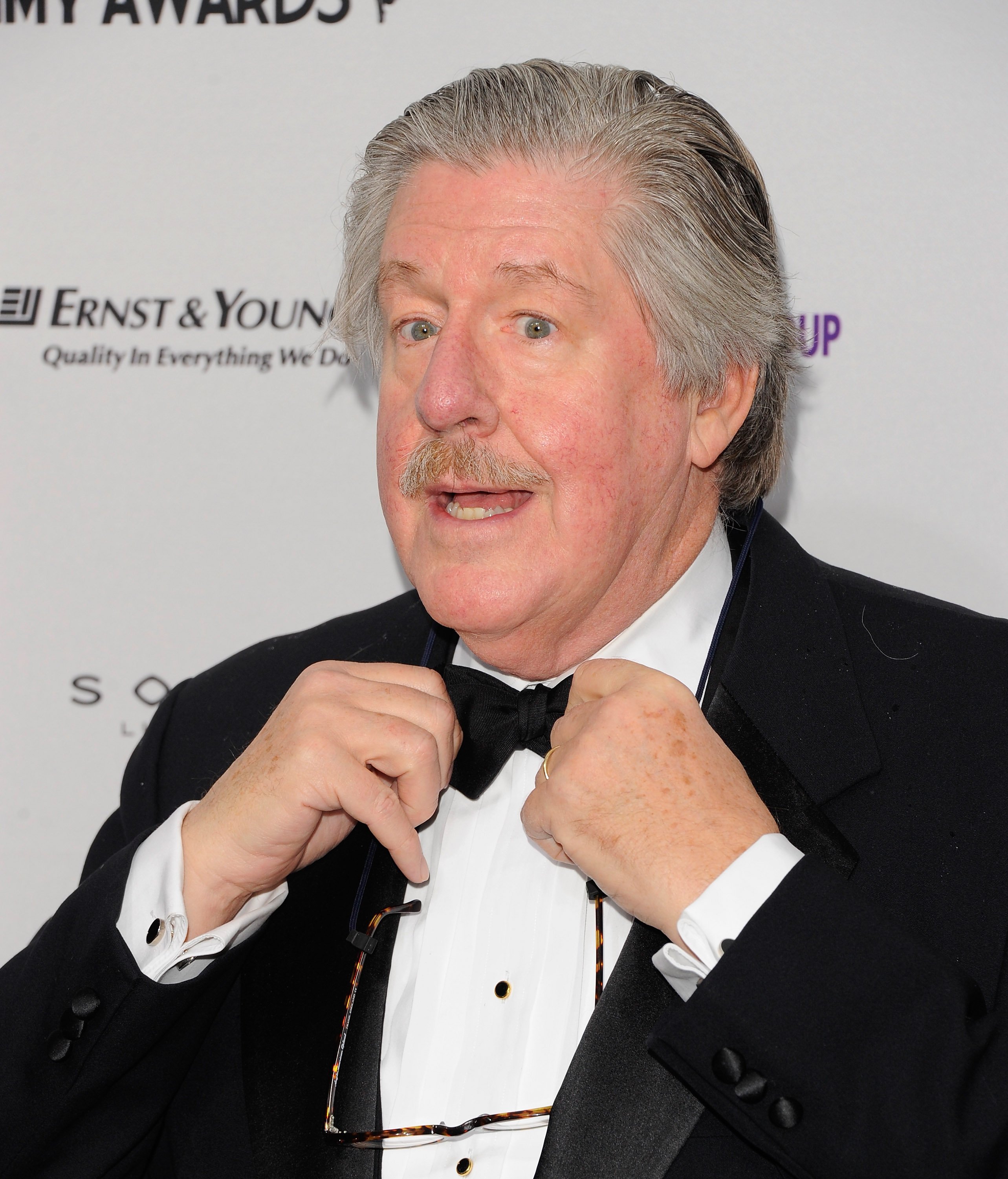 Edward Herrmann adjusts his bowtie during the 39th International Emmy Awards in 2011