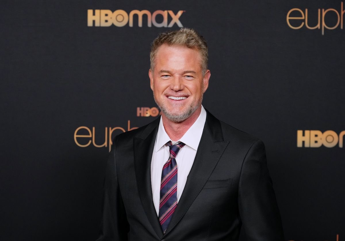 Eric Dane smiling in front of a black background