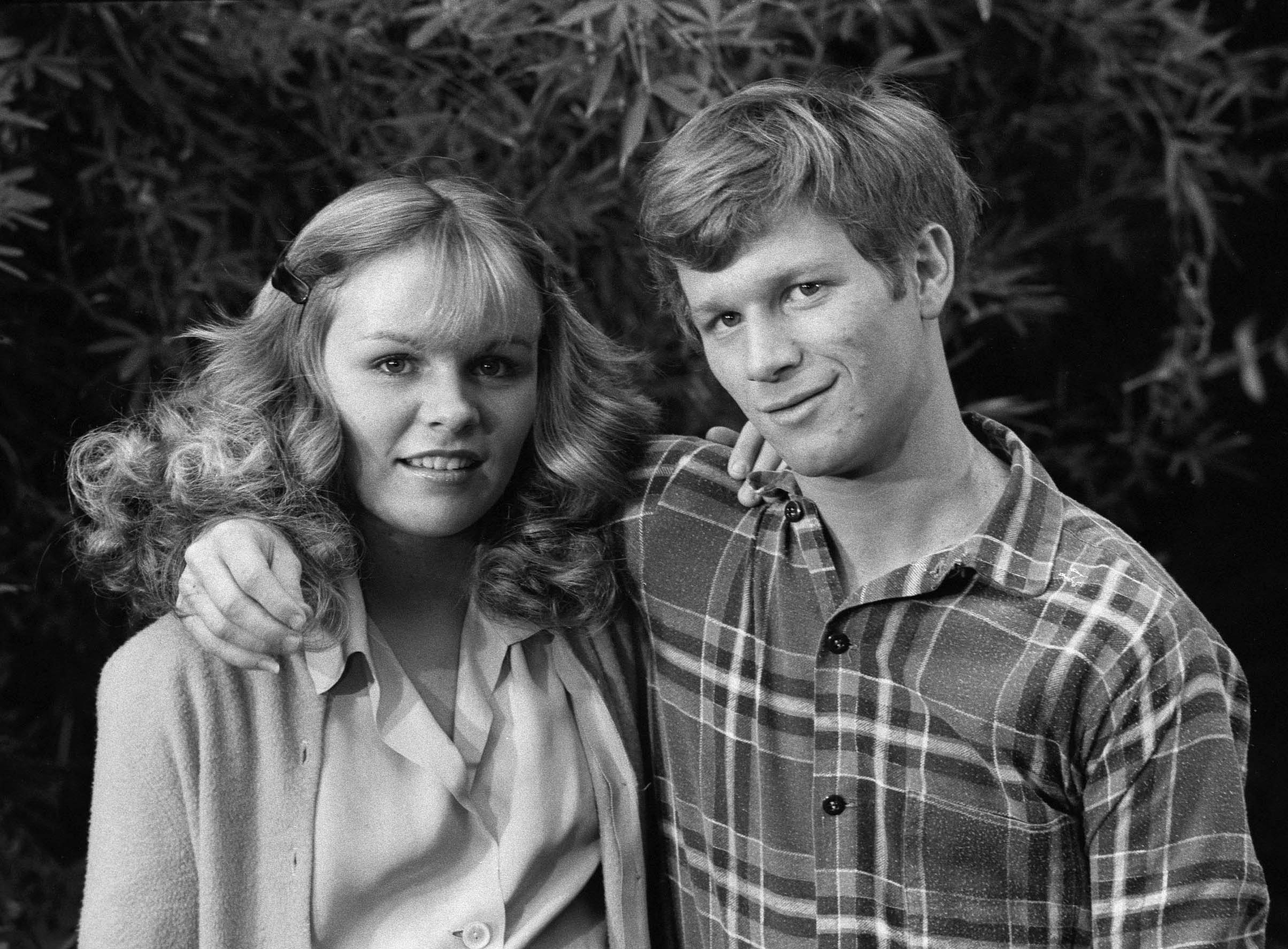 Black and white photo of 'The Waltons' cast member Eric Scott with his arm around Debbie Gunn