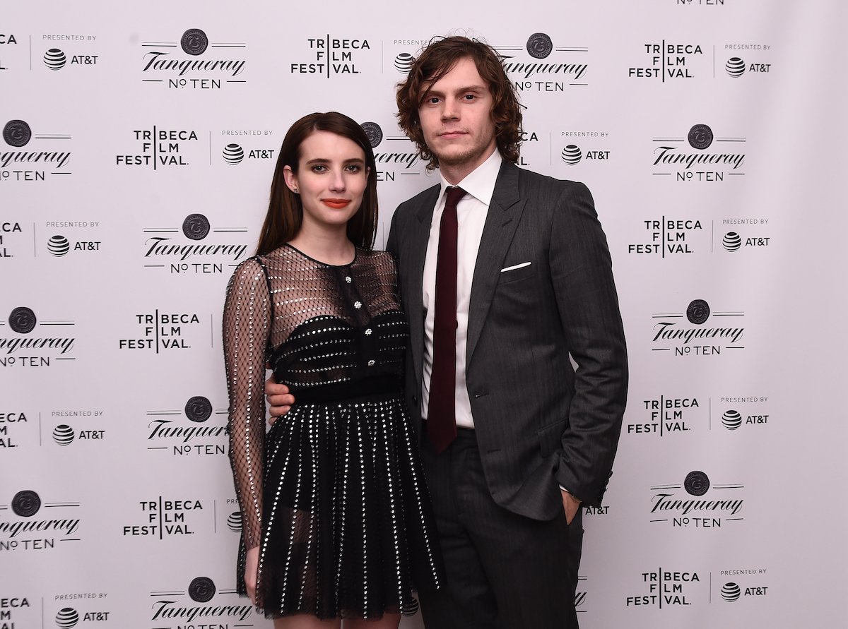 Emma Roberts and Evan Peters, who dated for eight years, smile and pose together at an event.