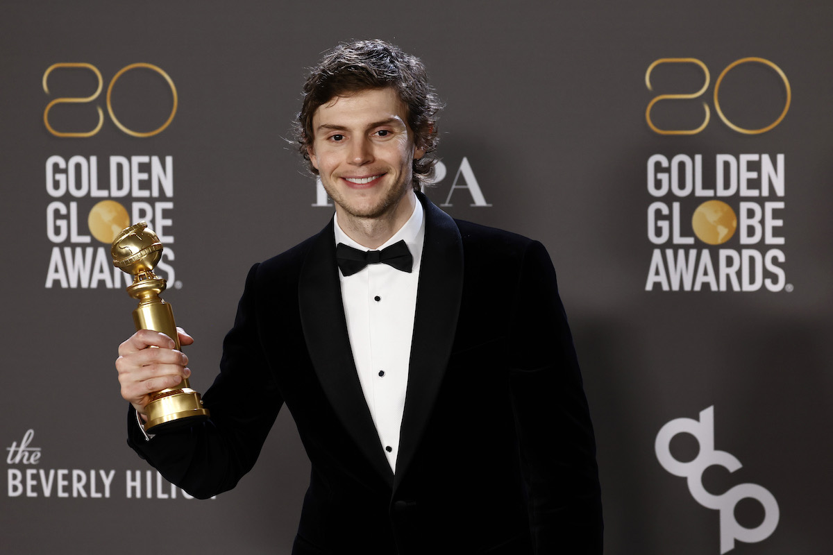 Evan Peters holds the Golden Globe Award he won for his portrayal of serial killer Jeffrey Dahmer.