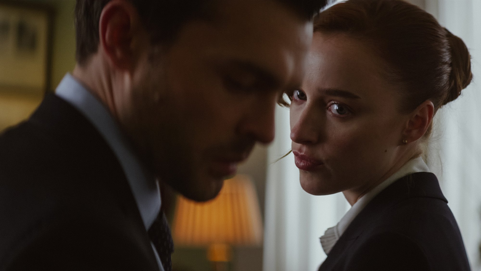 'Fair Play' Alden Ehrenreich as Luke and Phoebe Dynevor as Emily. Emily is looking at Luke, who is looking straight ahead from a profile