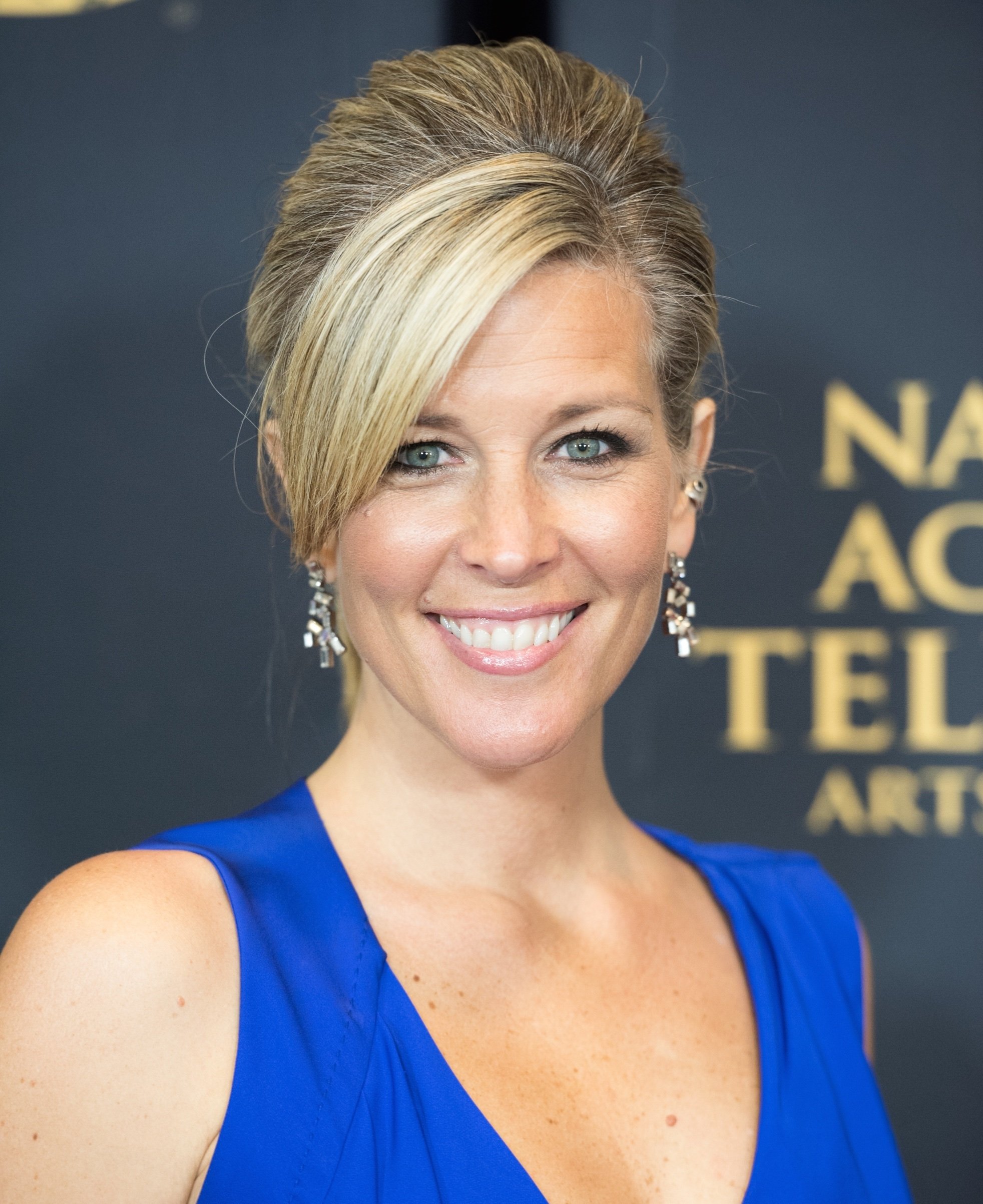 'General Hospital' star Laura Wright in a blue dress; poses on the red carpet.
