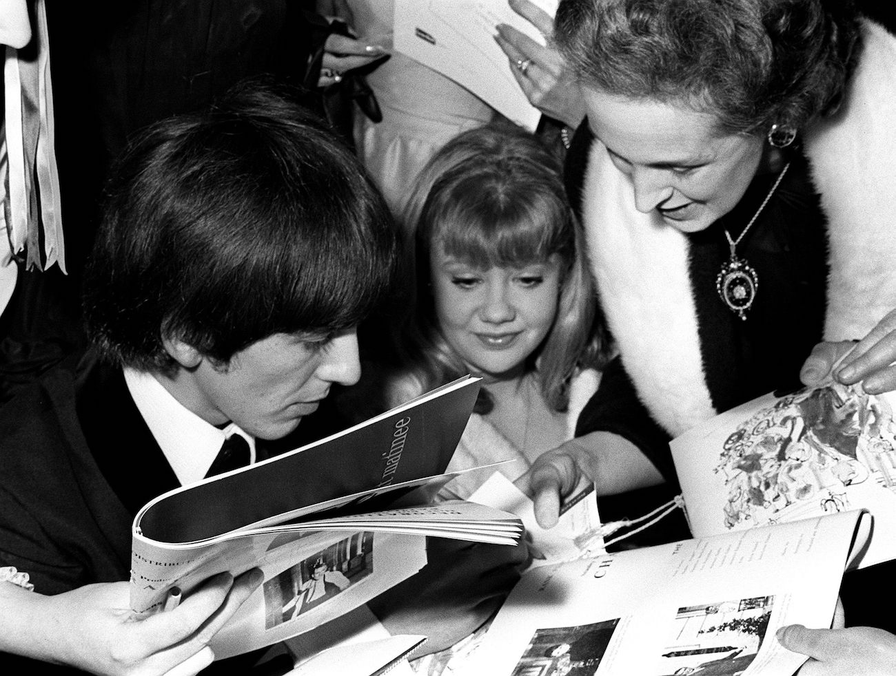 George Harrison and Hayley Mills at the Regal Cinema as fans crowd them for autographs. 