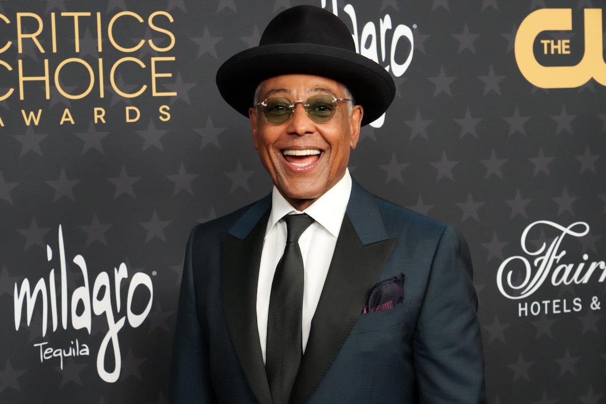 Giancarlo Esposito poses for photos in front of a black backdrop at the Critics Choice Awards