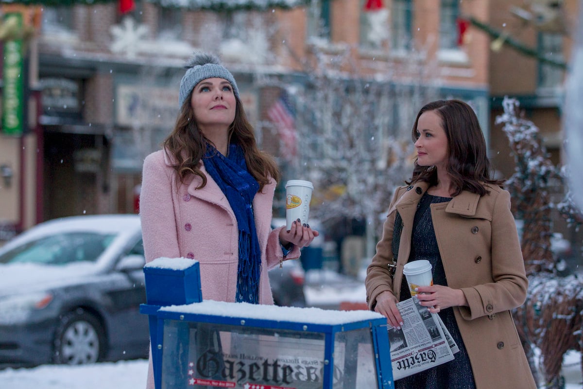 'Gilmore Girls' cast members Lauren Graham as Lorelai Gilmore and Alexis Bledel as Rory Gilmore standing in a snowy Stars Hollow
