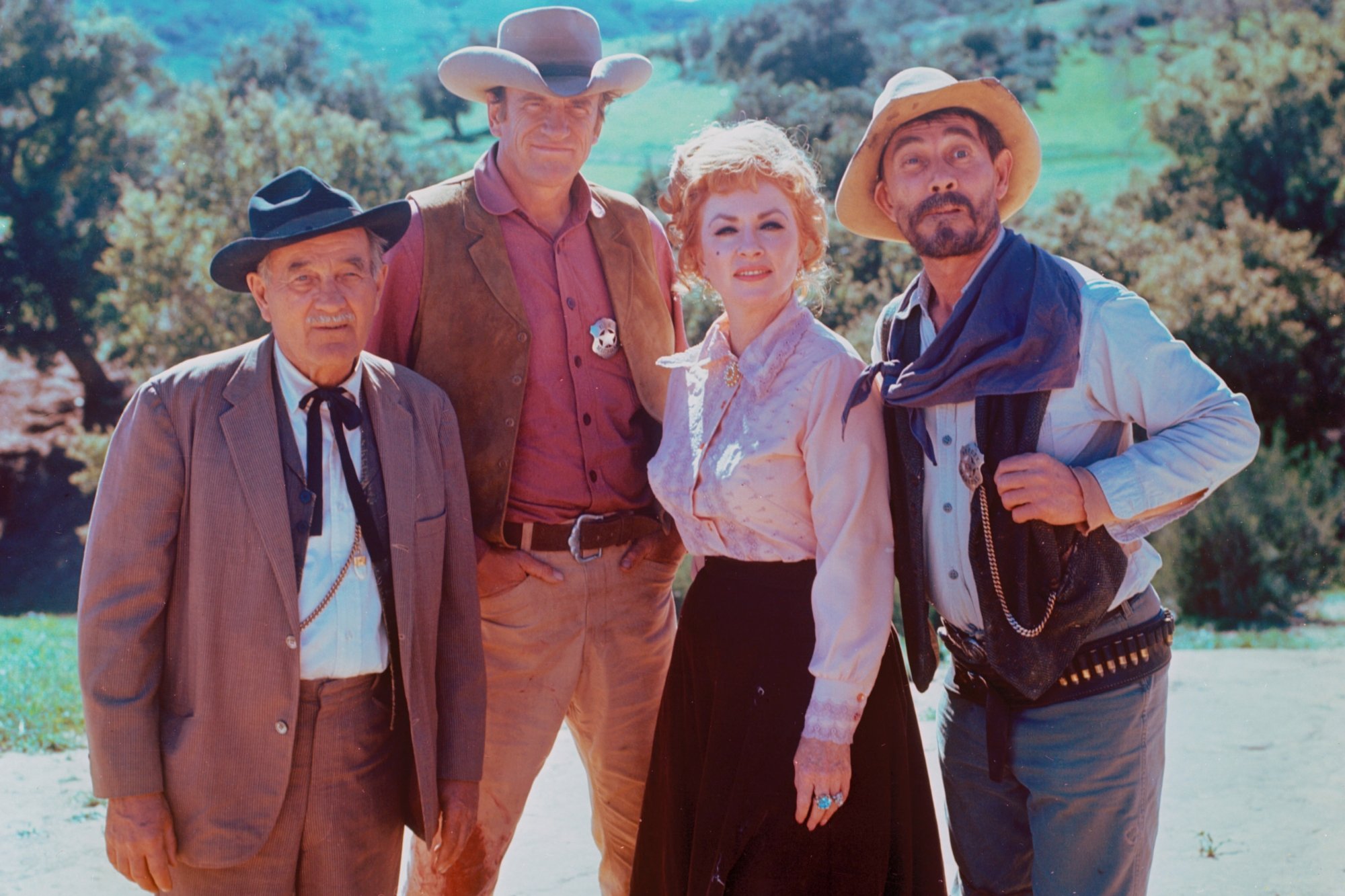 Golden Globes nominated 'Gunsmoke' Milburn Stone as Doc Adams, James Arness as Matt Dillon, Amanda Blake as Miss Kitty Russell, and Ken Curtis as Festus Haggen in a publicity photo in costume smiling