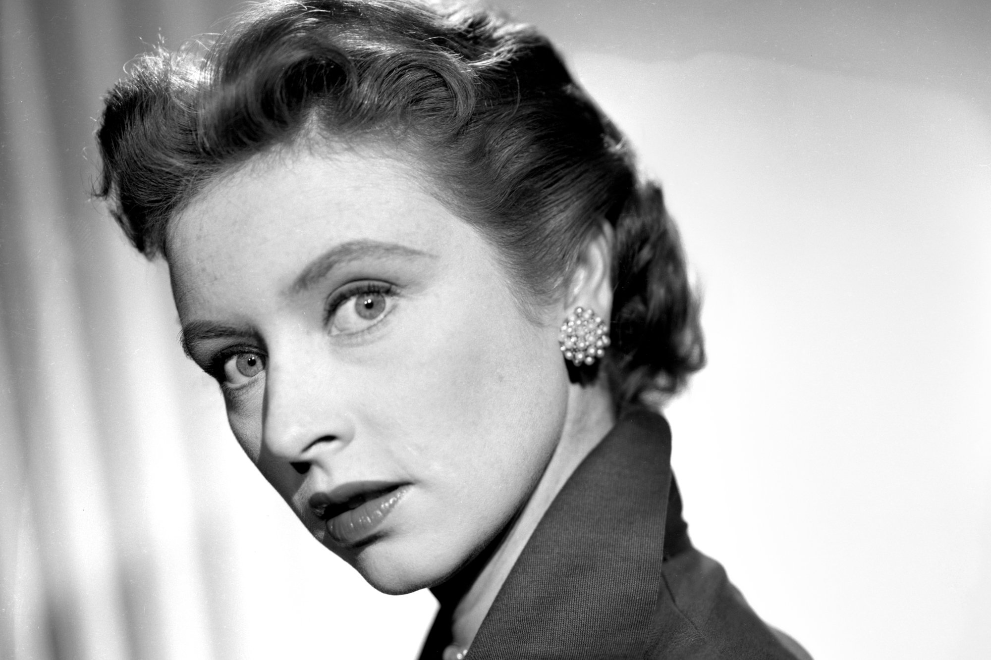 'Gunsmoke' Amanda Blake as Miss Kitty Russell in a black-and-white picture looking surprised over her shoulder