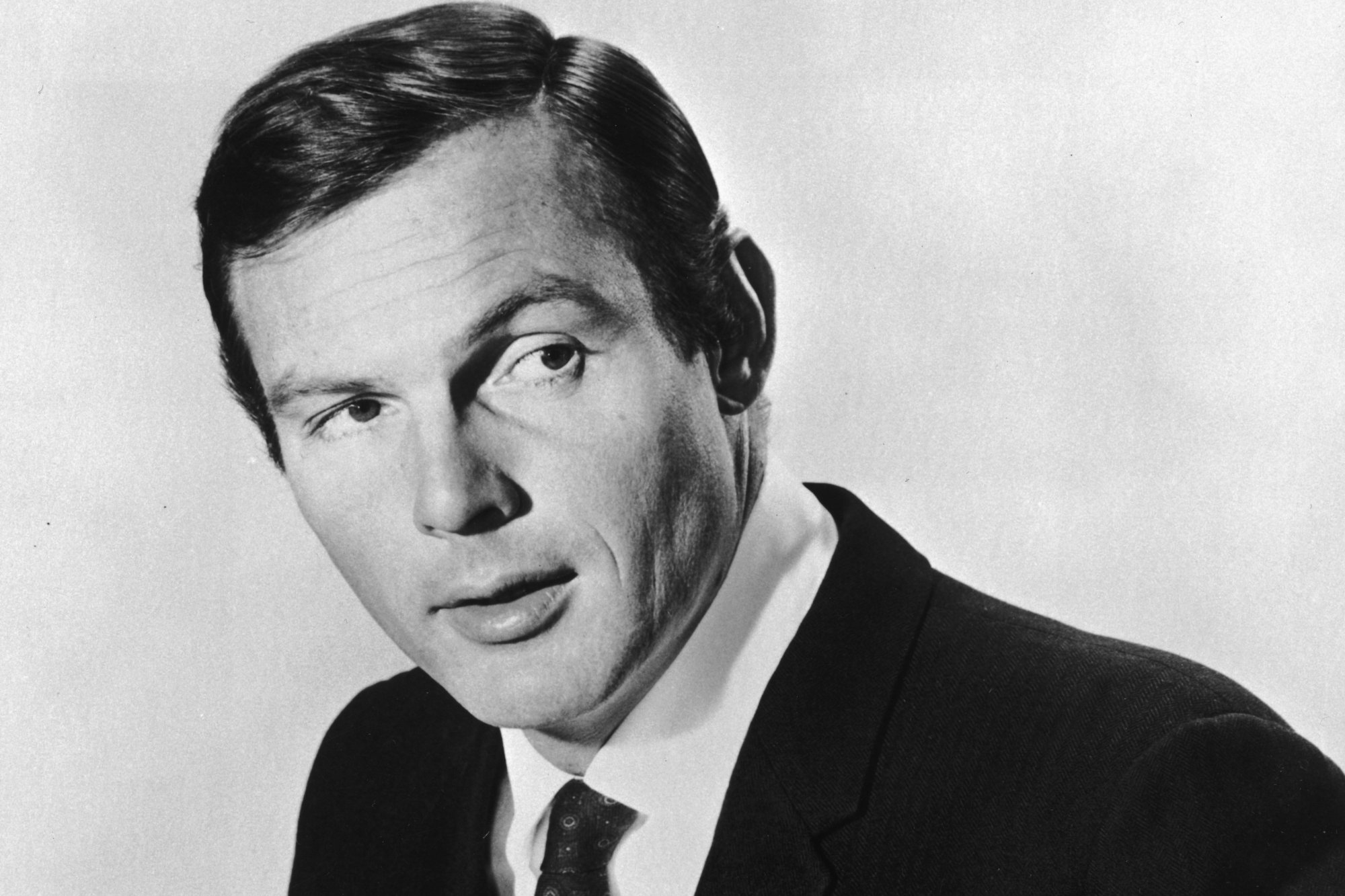 'Gunsmoke' guest star Adam West in a promo image wearing a suit and tie looking off to one side
