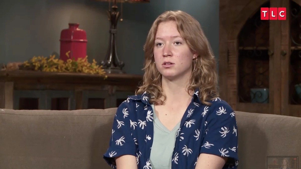 Gwendlyn Brown sitting on a couch during an interview for 'Sister Wives' on TLC.