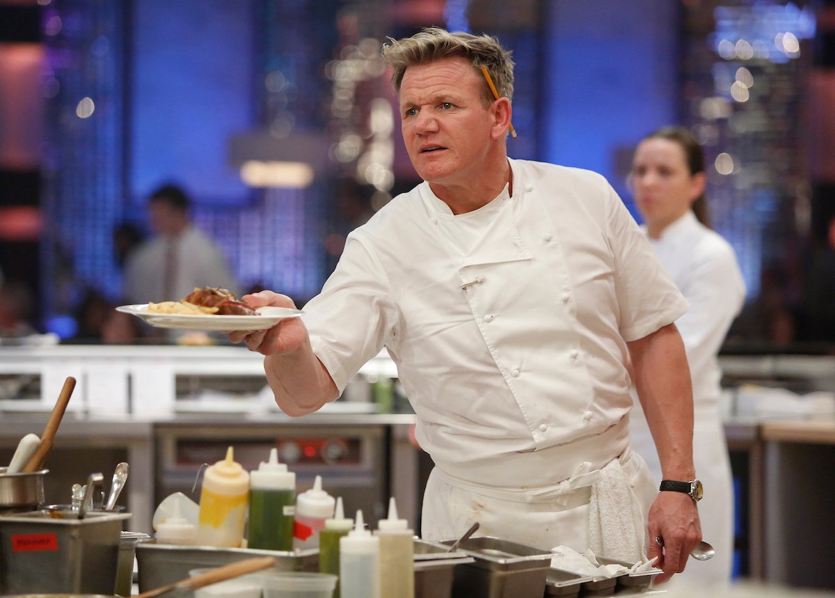 Chef Gordon Ramsay holds a dish on set of "Hell's Kitchen."