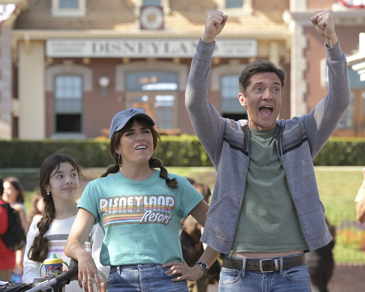 Marina and Tom stand together at Disneyland in a season 3 episode of 'Home Economics' 