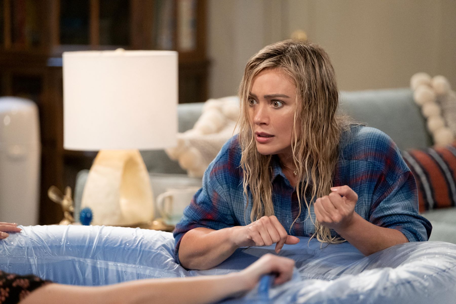 Hilary Duff, in character as Sophie in 'How I Met Your Father' Season 2, wears a blue and red plaid button-up shirt.