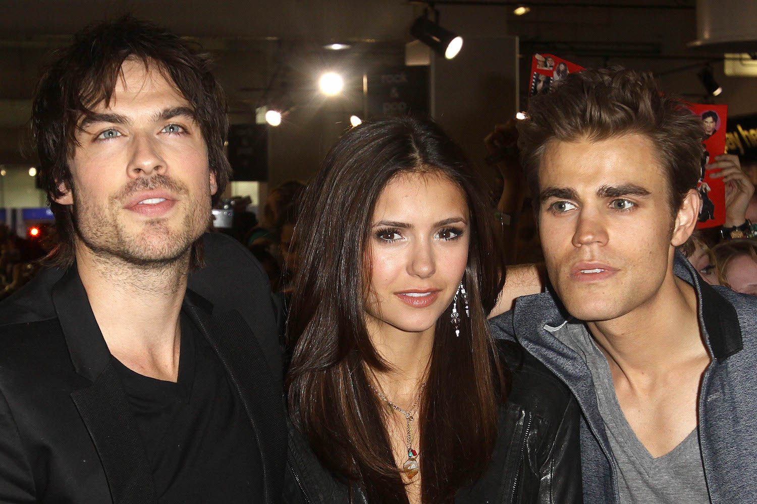 Ian Somerhalder, Nina Dobrev, and Paul Wesley from 'The Vampire Diaries' standing next to one another