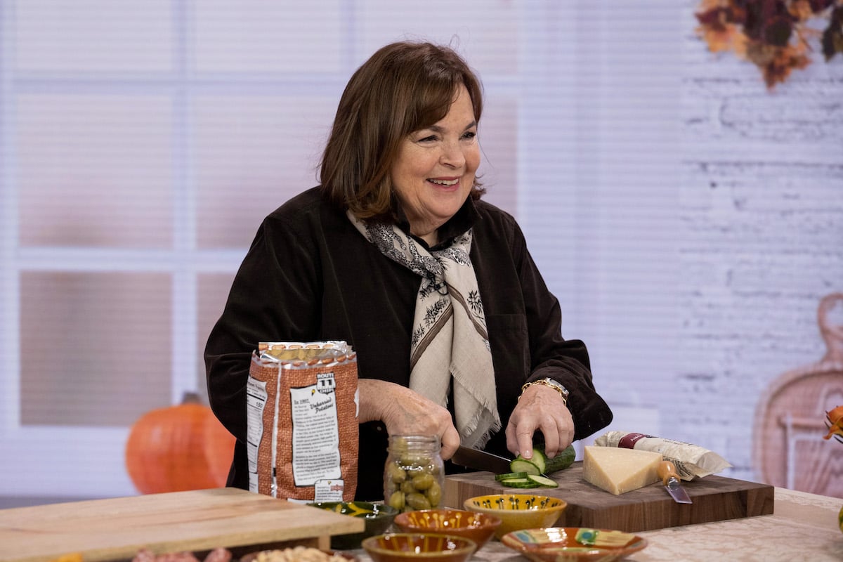 Ina Garten, who shared her reaction to seeing the 'Barefoot Contessa' premiere, slices vegetables