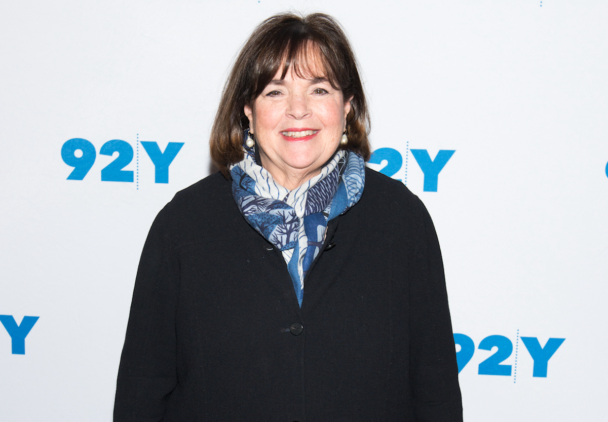 Ina Garten, who said it's OK to order pizza for entertaining, smiles wearing a black jacket and blue printed scarf