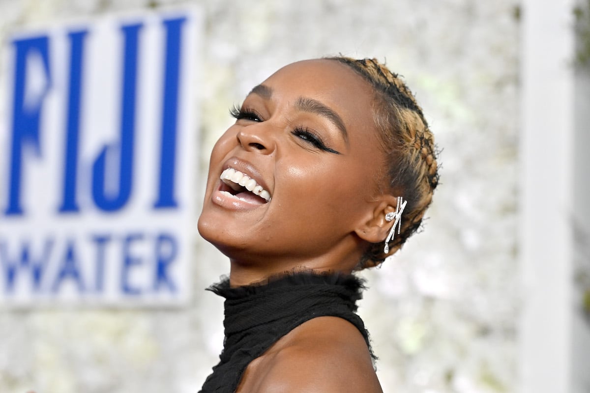 Janelle Monáe laughs while posing for pictures at the Critics Choice Awards.