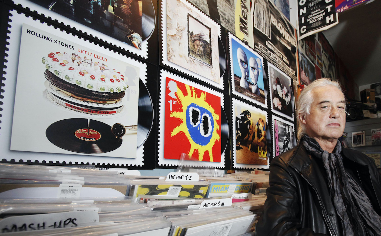 Led Zeppelin guitarist Jimmy Page stands next to a blown up image of the 'Led Zeppelin IV' album cover in 2010 when England's Royal Mail turned the artwork into a commemorative stamp.