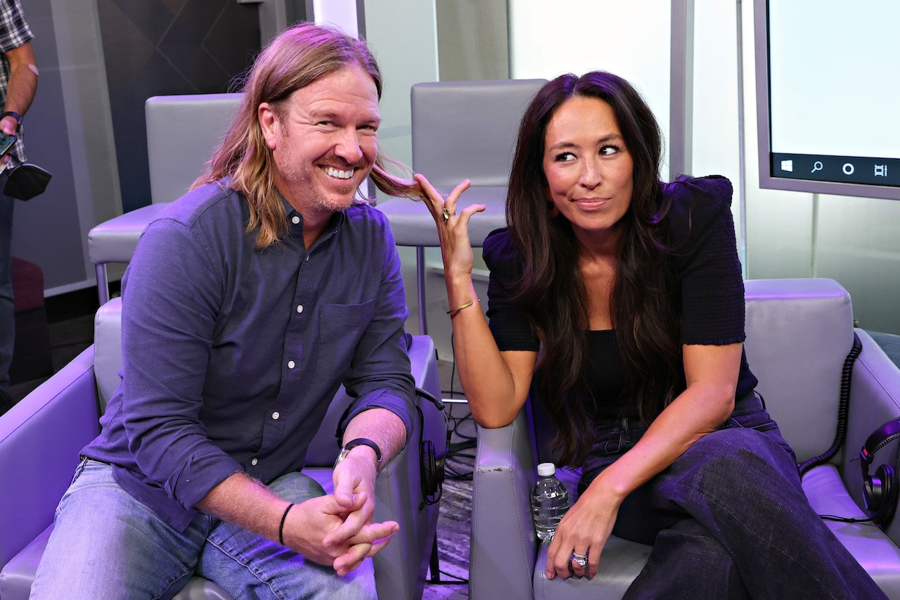 Chip and Joanna Gaines with Hoda Kotb for a 'Today Show Radio' event in 2021. Joanna recently shared a 'windy day selfie' that shows they are a family of great hair.