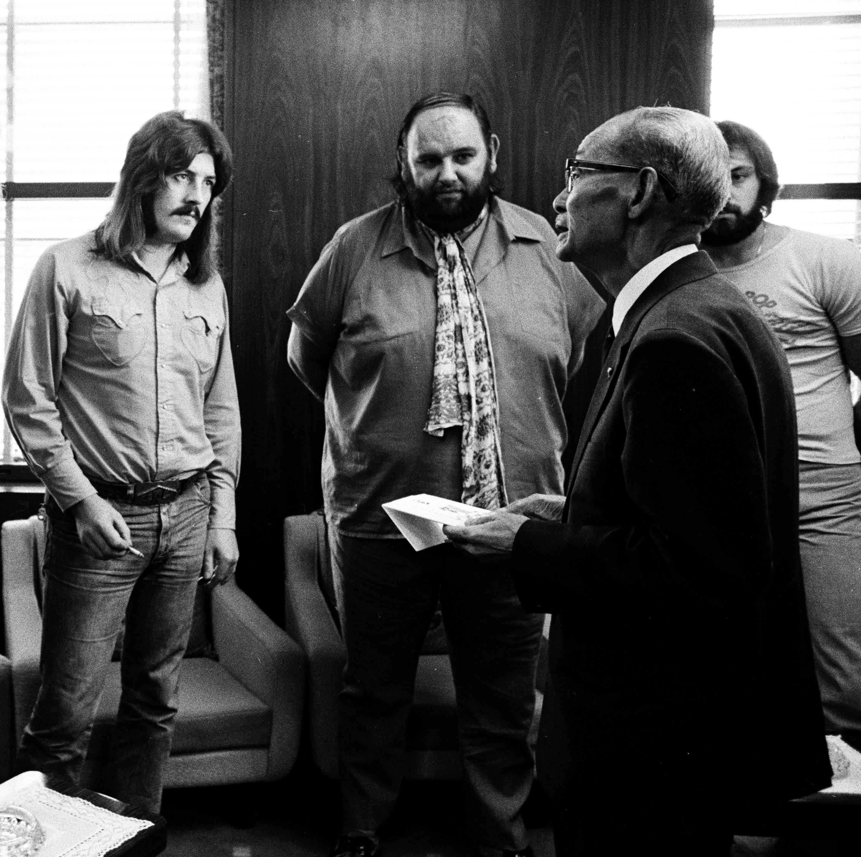 Led Zeppelin drummer John Bonham (left) stands next to the band's manager, Peter Grant, while meeting the mayor of Hiroshima, Japan, in 1971.